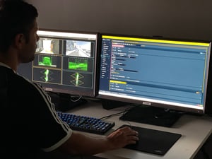 A man sitting in front of two computer screen showcasing Pixotope software