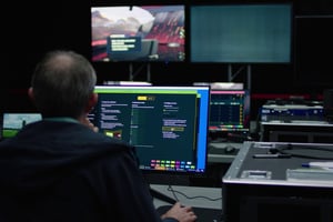 Man sitting at the computer and operating Pixotope software